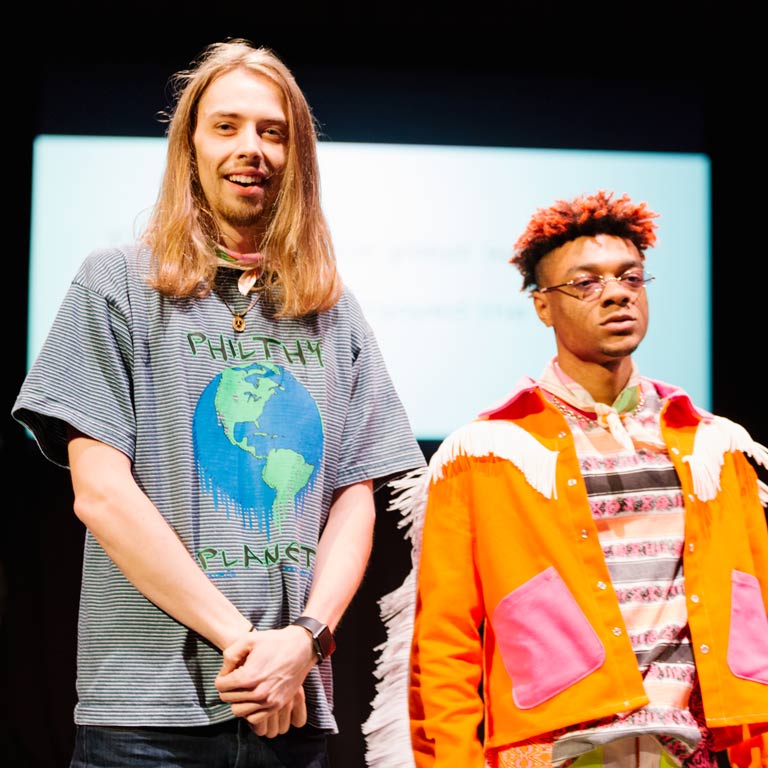 Two people on a runway.