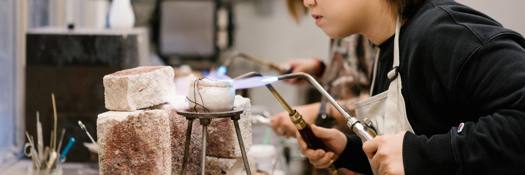 A person using blowtorches on their project.