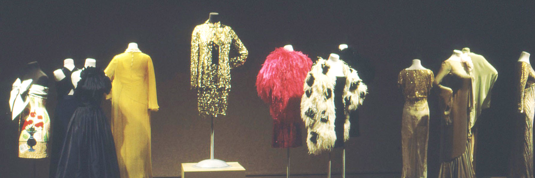 A row of mannequins wearing clothes. 