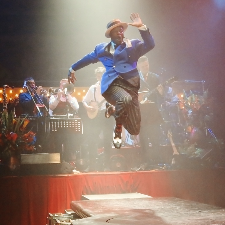 A row of mannequins wearing clothes. 