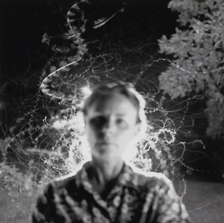 A blurry person facing the camera.