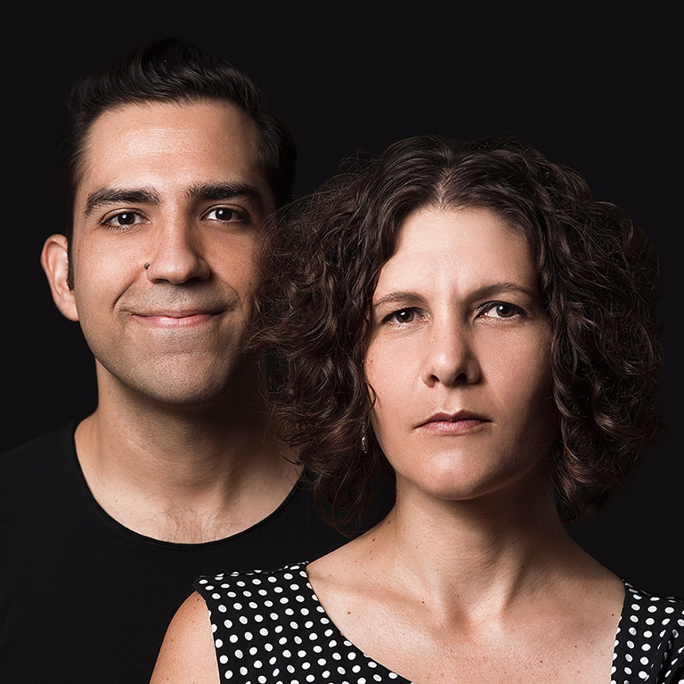 Two people look at the camera.