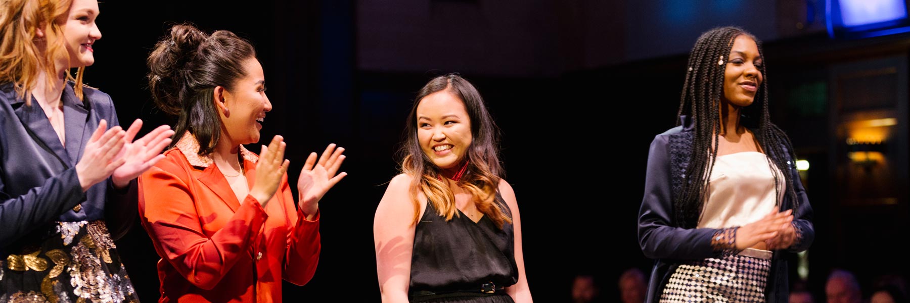 Students smile together on the runway.