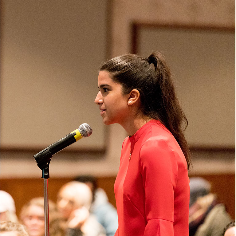 A person speaks into a microphone.
