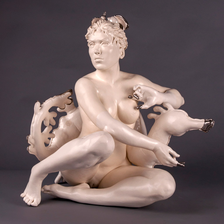 A sculpture of a naked person on a seahorse.