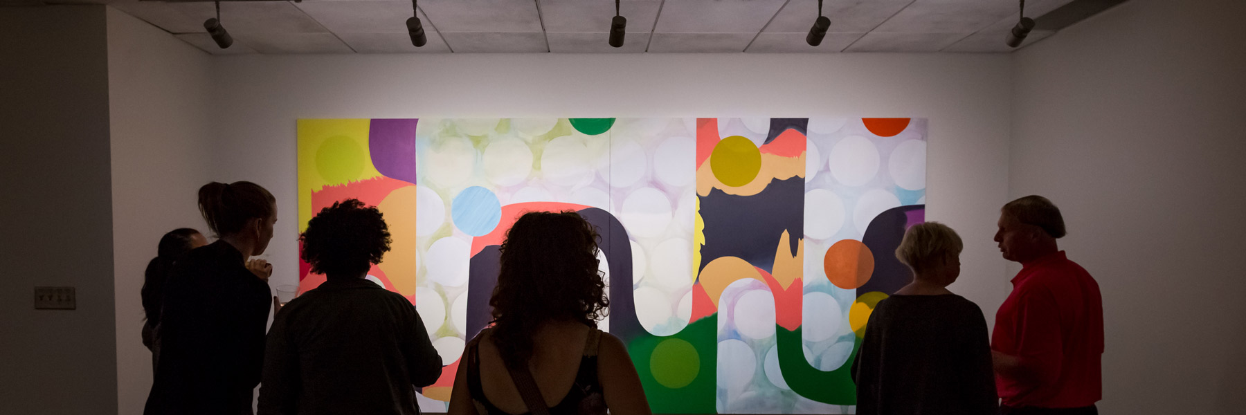 People looking at art in a gallery.