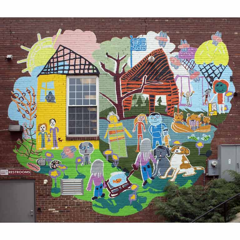 A colorful mural painted on the side of a brick building.
