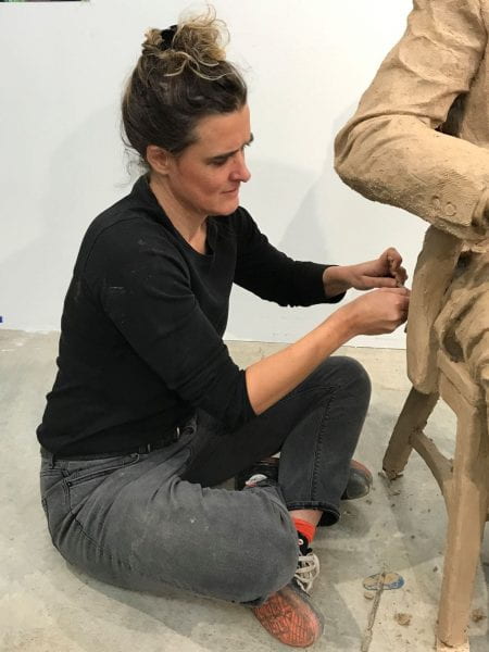 A colorful mural painted on the side of a brick building.