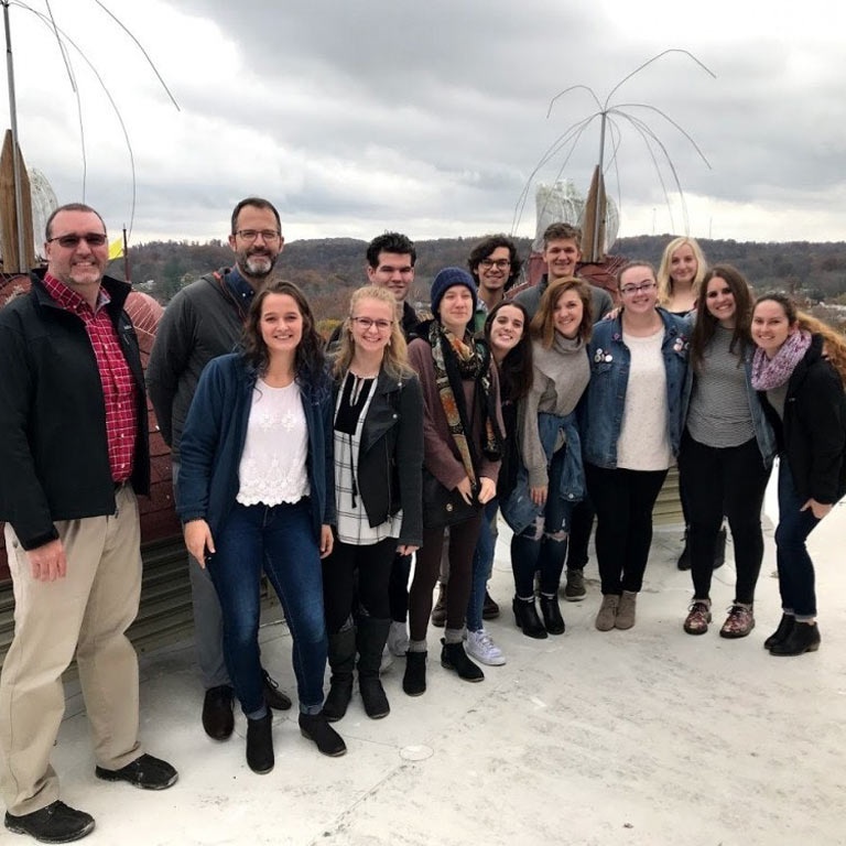 A group of people stand outside