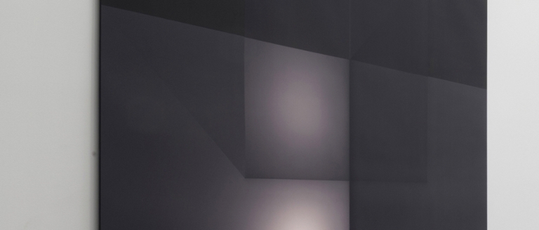 An art canvas hangs on a wall