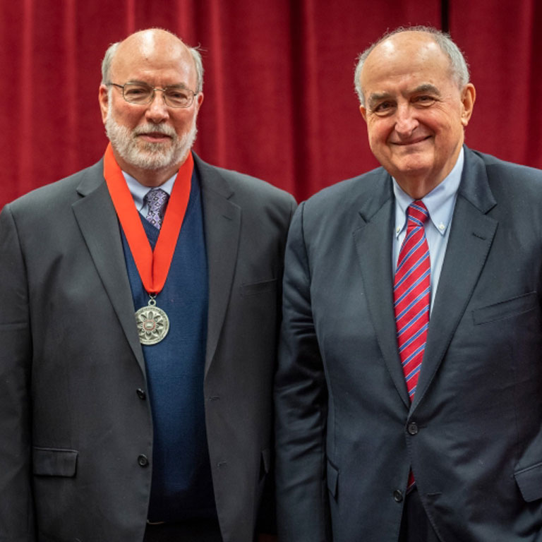 President McRobbie stands with John Burnett