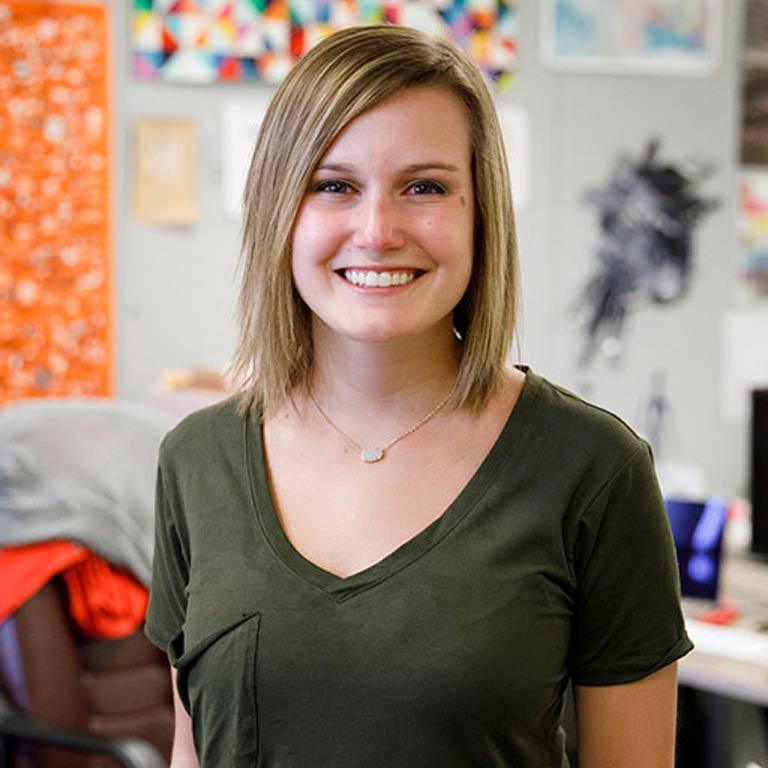 A woman smiles at the camera.