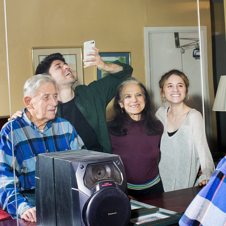 People stand behind a camera.