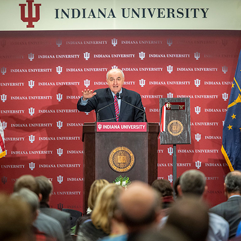 President McRobbie speaks behind a podium