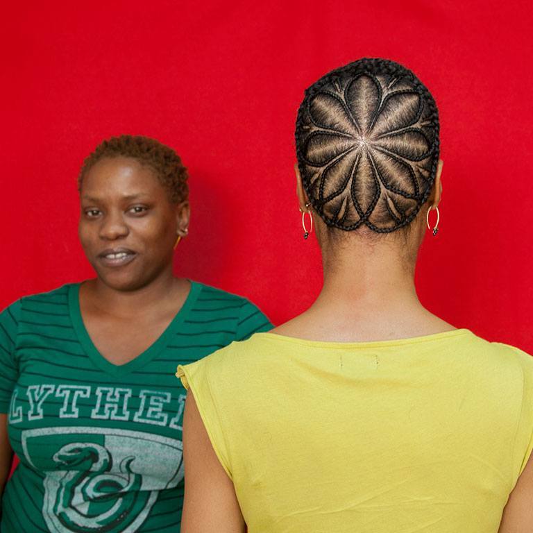 A flower design done with the hair of a person of color