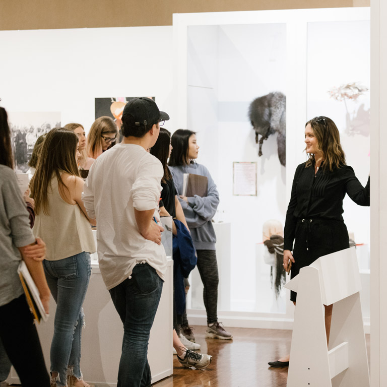 A group of students given a tour in a museum.