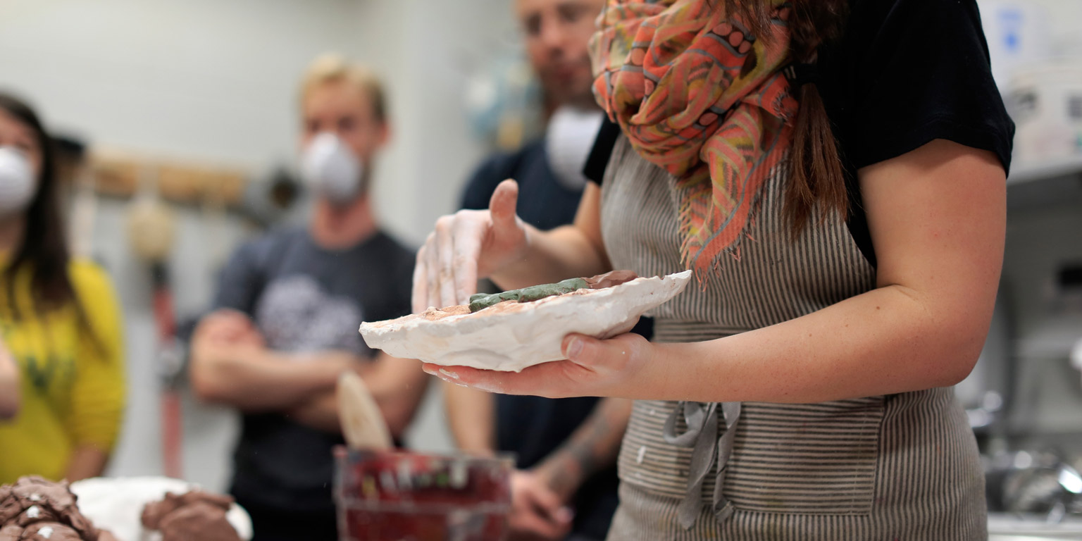 A person gives a clay demonstration.