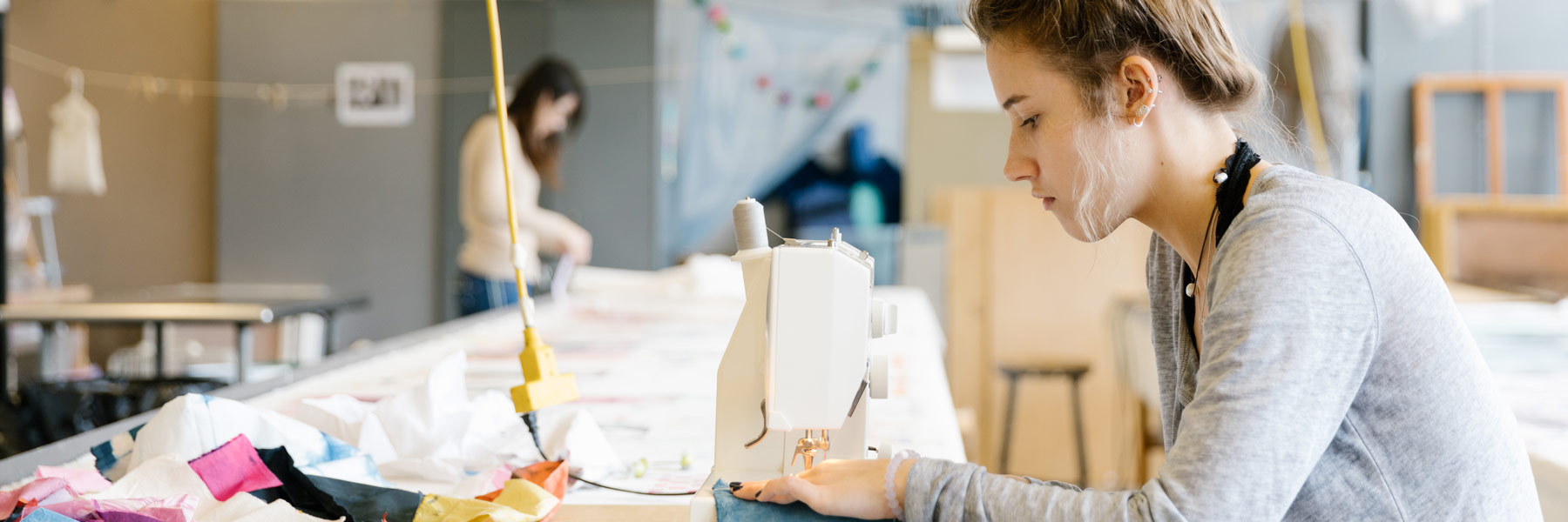 A person works at a sewing machine.