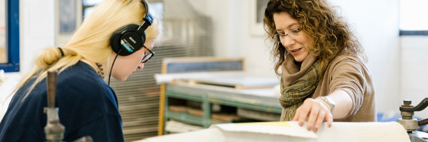 A professor and student make a print.