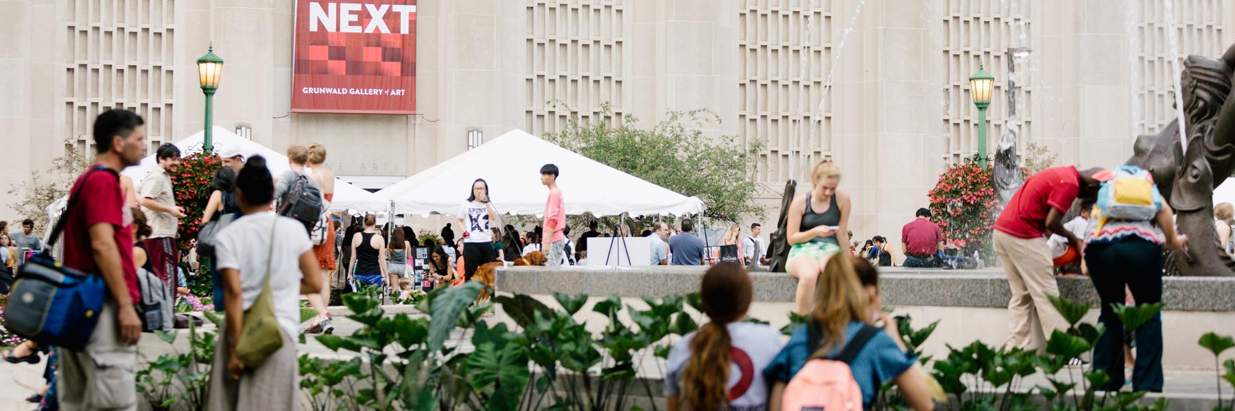People sit in front of a fountain.